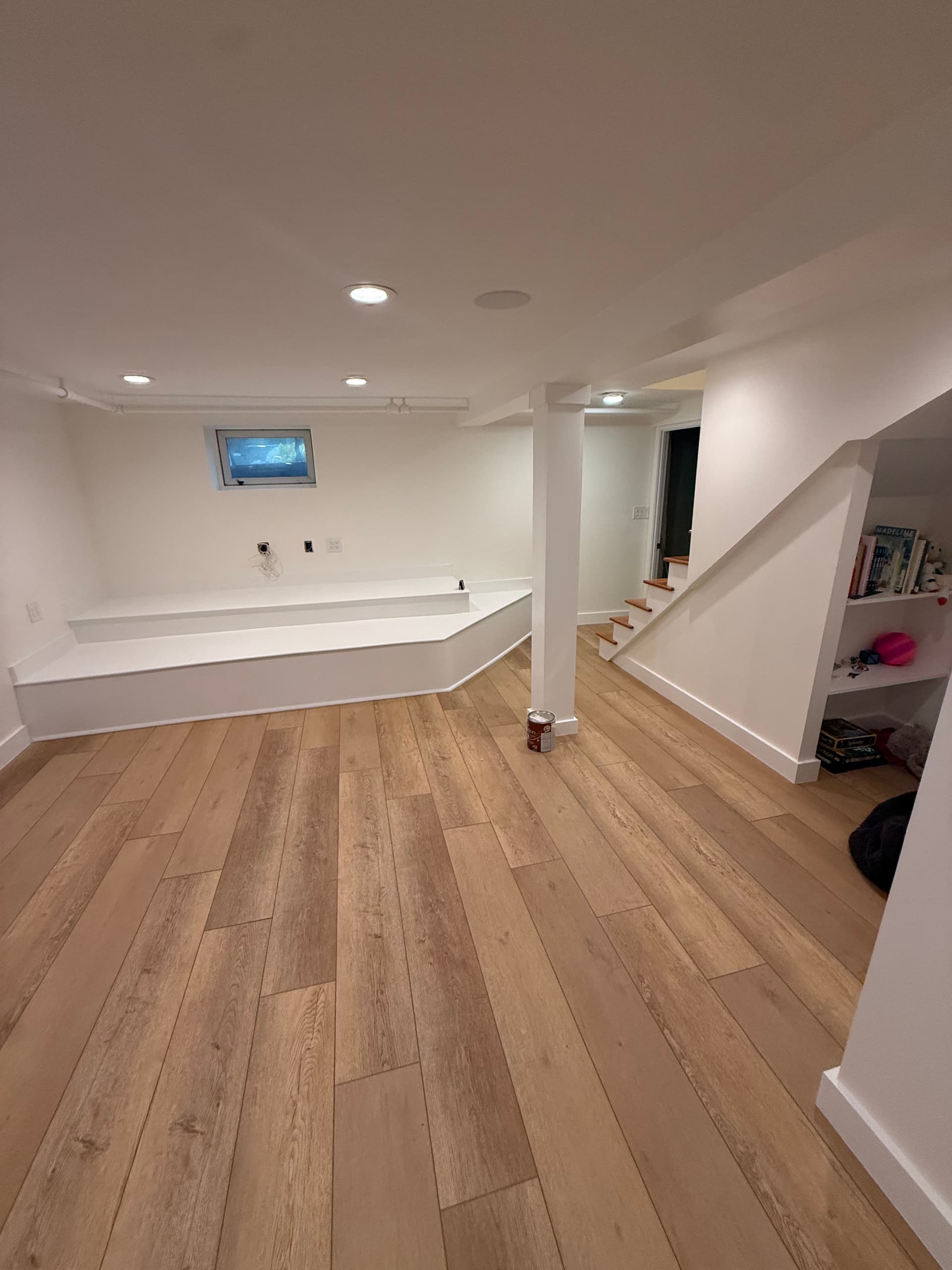A beautifully finished basement with a cozy nook, showcasing the quality of our basement finishing services in Boston.